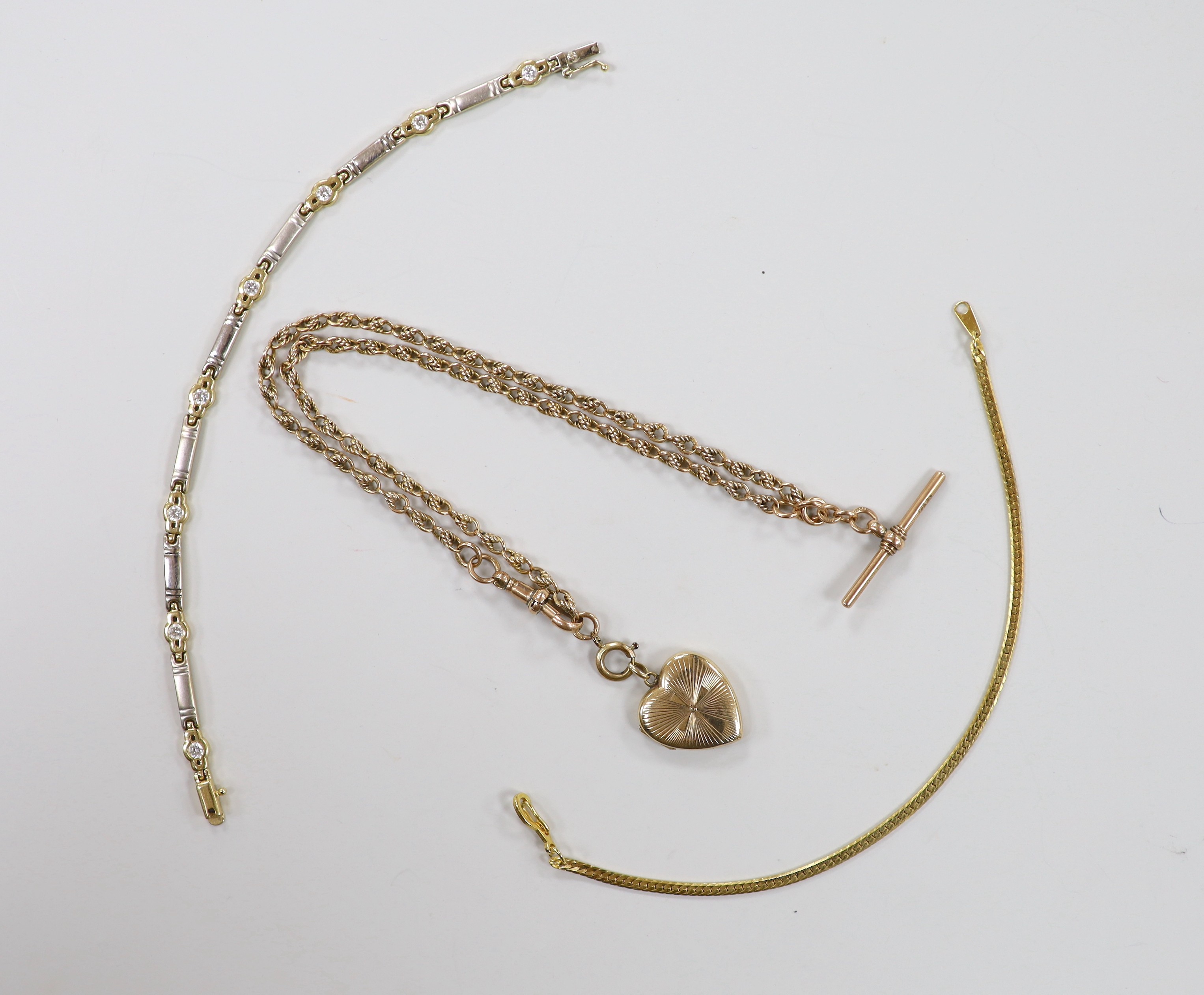 A 1940's 9ct gold heart shaped locket, 21mm, on a 9ct gold fancy link albert, 42cm, gross 18.5 grams, together with a 14k and simulated diamond set bracelet, gross 8.1 grams and one other bracelet.